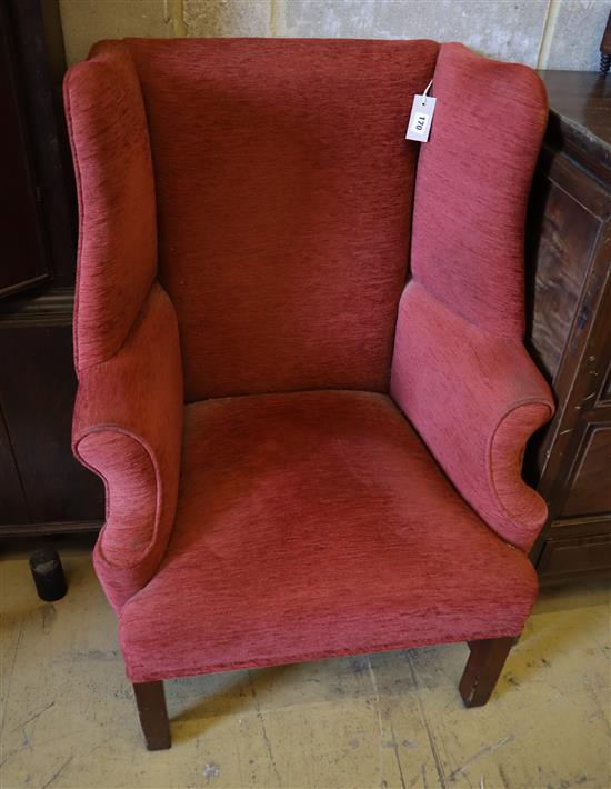 A George III style red dralon upholstered mahogany framed wing armchair